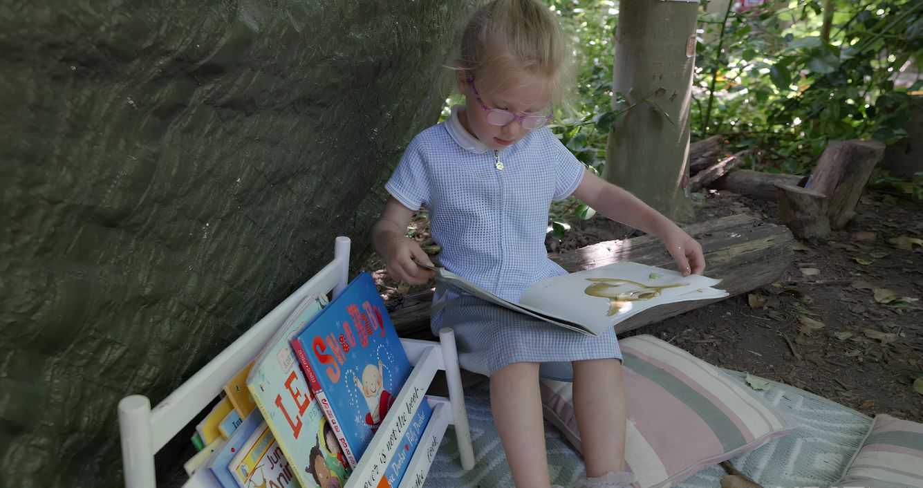 Nursery children enjoying story time and small world play